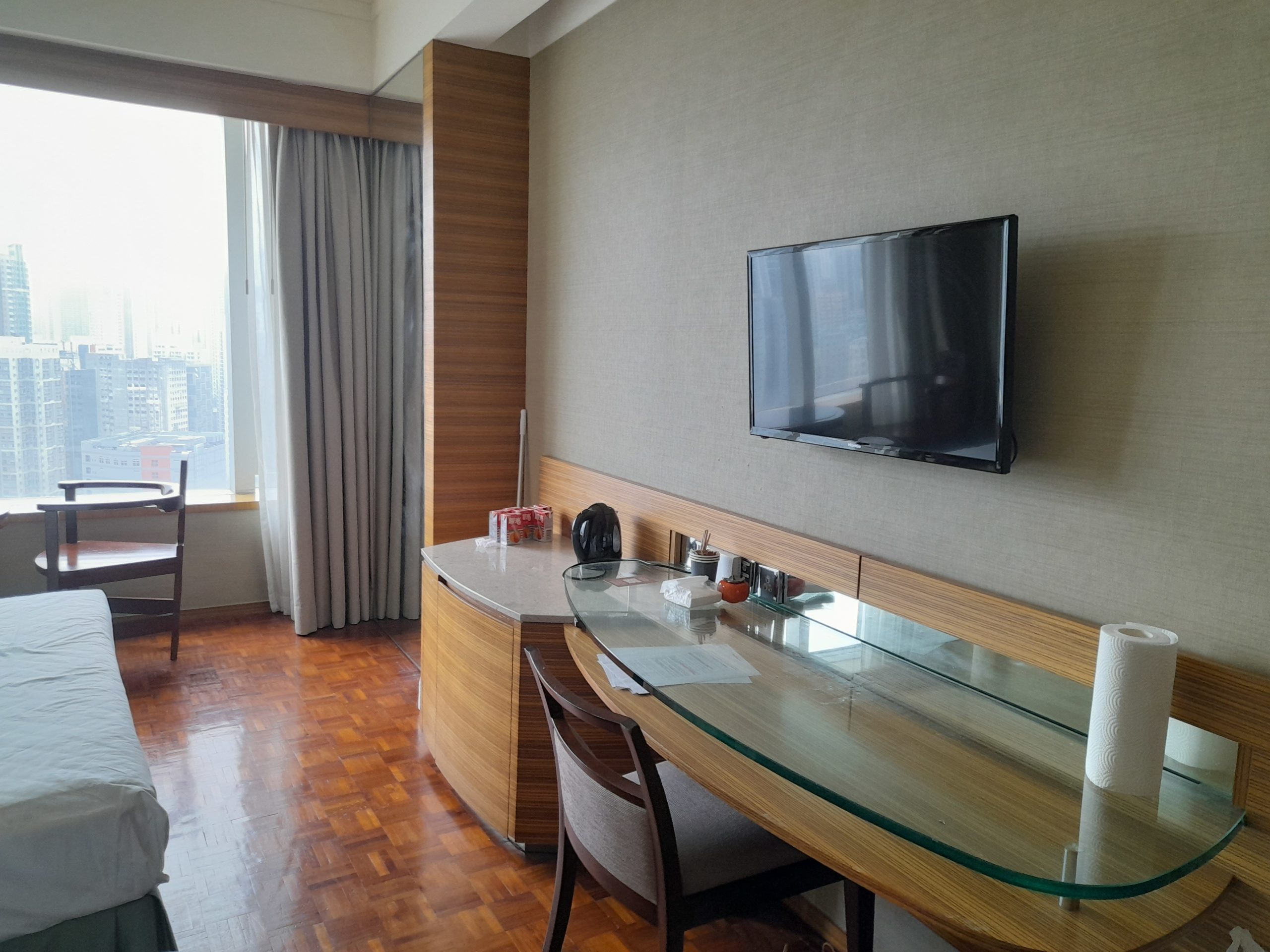 Wide table with glass top and cushioned chair